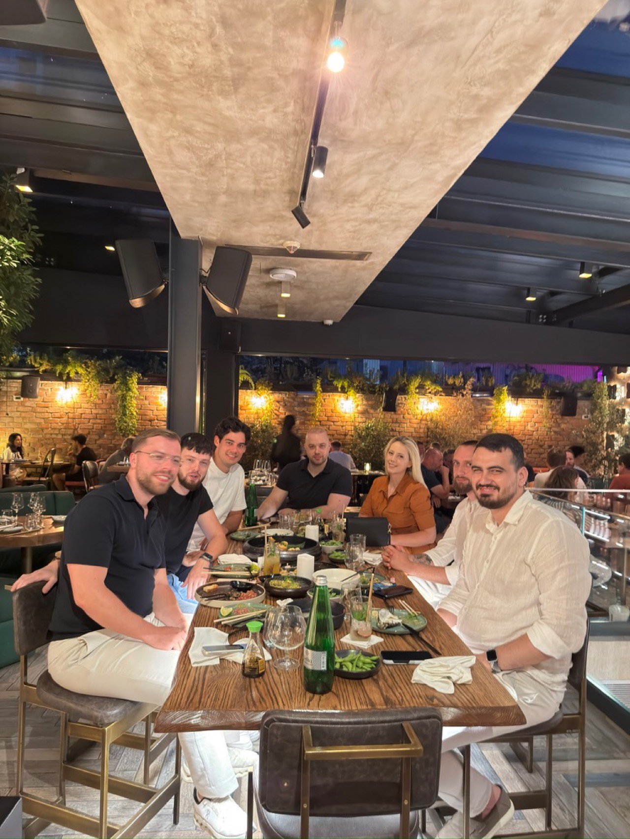 Het BCS-team aan een lange tafel tijdens een teamdiner